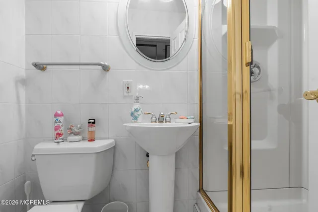 a bedroom with a bed a couch and dresser