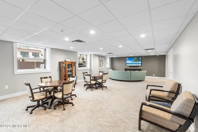 a large kitchen with kitchen island a large counter top stainless steel appliances and cabinets