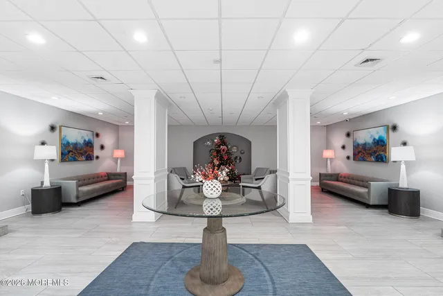 a living room with furniture and flowers