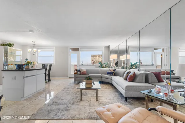 a living room with furniture fireplace and a large window
