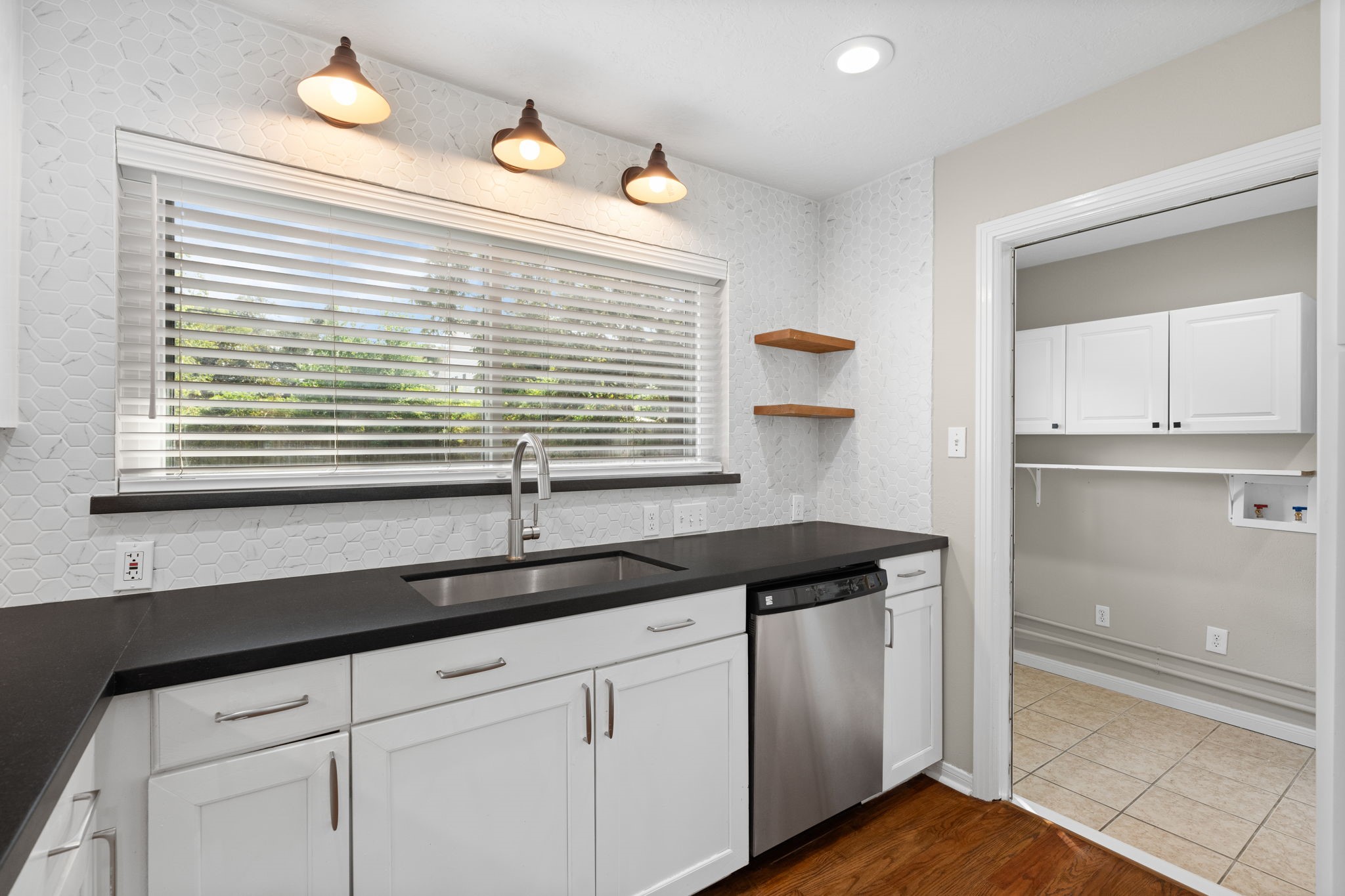 2007 Wakefield Drive Houston, TX 77018 - Photo 12 of 29 Enjoy a fully updated kitchen with modern, warm touches designed for everyday living. Open to the dining area, laundry room, and backyard door, making cooking, chores, and entertaining effortless—perfect for a lifestyle that balances comfort and convenience.