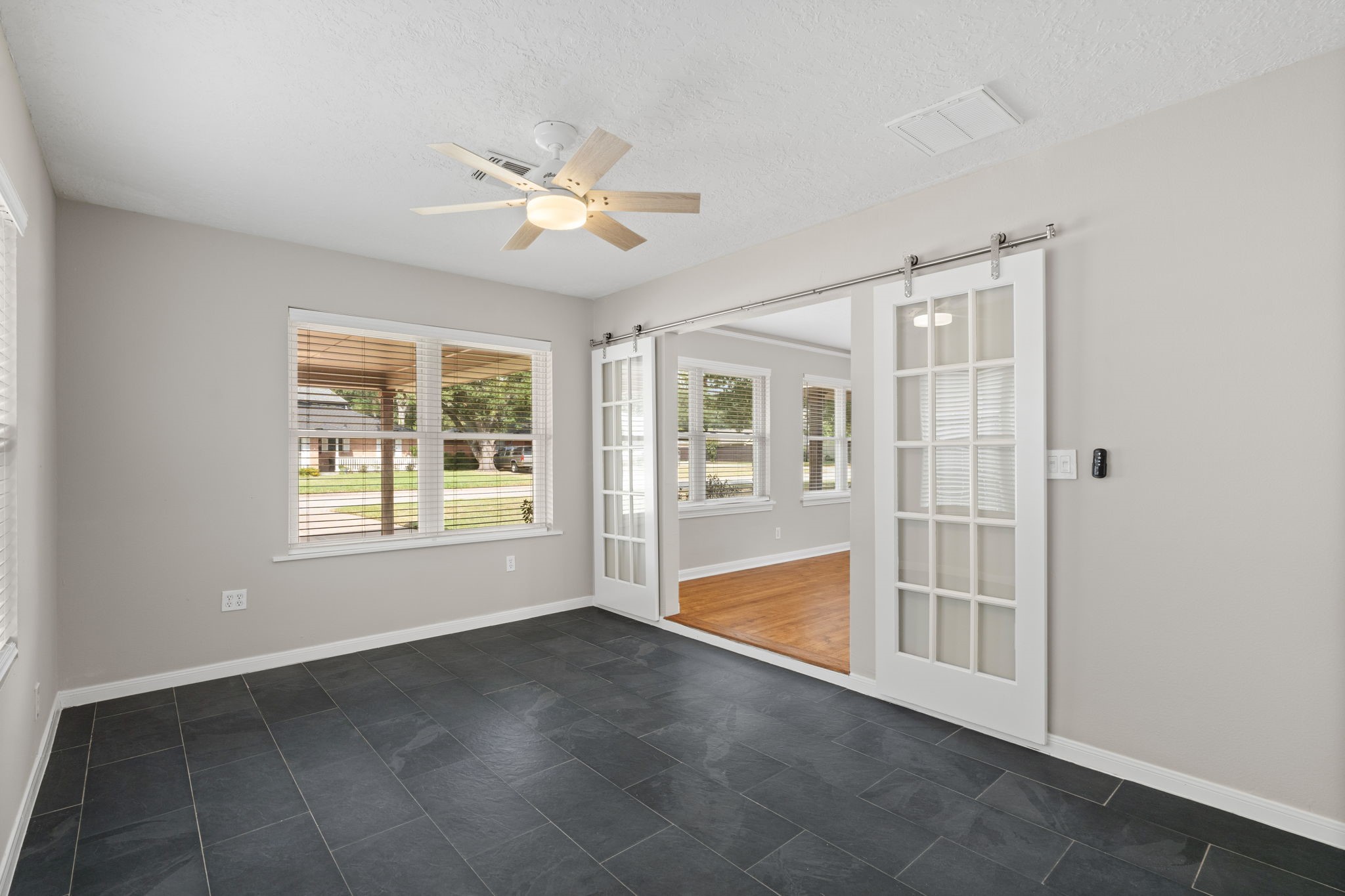 2007 Wakefield Drive Houston, TX 77018 - Photo 15 of 29 Enjoy the privacy and comfort of a fully updated primary bedroom. Spacious and bright, it includes a modern en suite bathroom, a generous closet, and elegant sliding barn doors—ideal for relaxing after a long day.