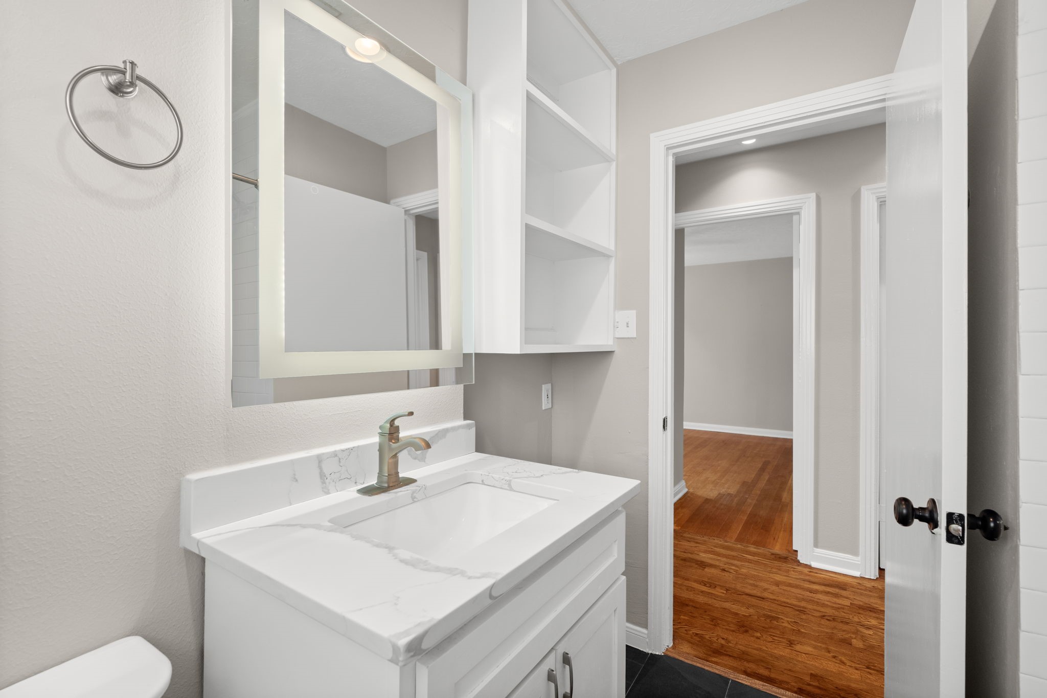 2007 Wakefield Drive Houston, TX 77018 - Photo 21 of 29 Fully updated full bathroom featuring a modern shower/tub combo with a recessed shelf and a sleek light-up mirror. Bright, stylish, and functional, this space makes daily routines and relaxing soaks both convenient and enjoyable.