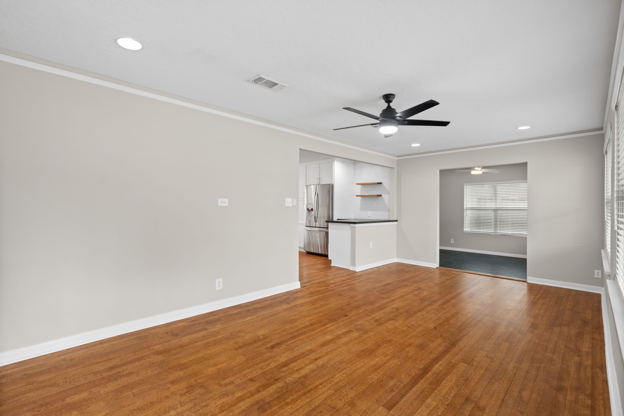 2007 Wakefield Drive Houston, TX 77018 - Photo 5 of 29 Enjoy the comfort of an open living and dining layout designed for both style and ease. Bright natural light, easy-to-maintain hardwood floors, and a fresh modern design make this space perfect for relaxing or entertaining.