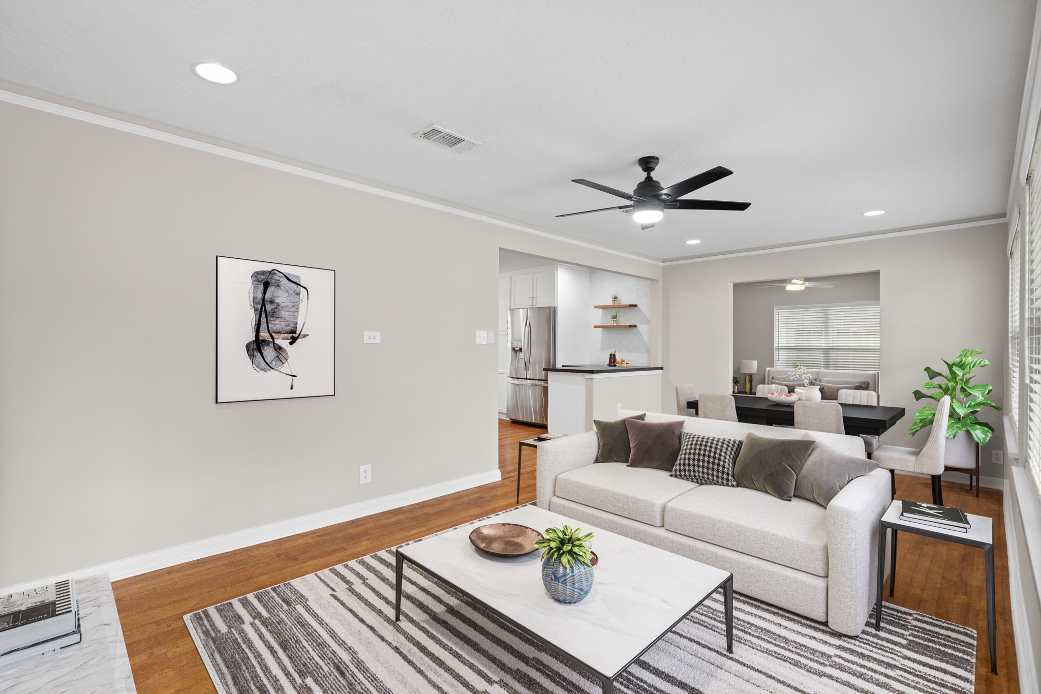 2007 Wakefield Drive Houston, TX 77018 - Photo 6 of 29 Virtually staged to show its full potential, this open-concept living and dining area is filled with natural light and charm. The easy flow, hardwood floors, and modern neutral palette make it easy to imagine your furniture and style fitting right in.