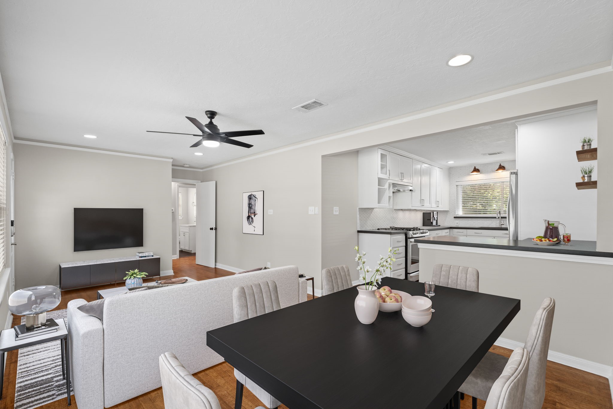 2007 Wakefield Drive Houston, TX 77018 - Photo 8 of 29 Virtually staged to show its full potential, this open-concept living and dining area is filled with natural light and charm. The easy flow, hardwood floors, and modern neutral palette make it easy to imagine your furniture and style fitting right in.