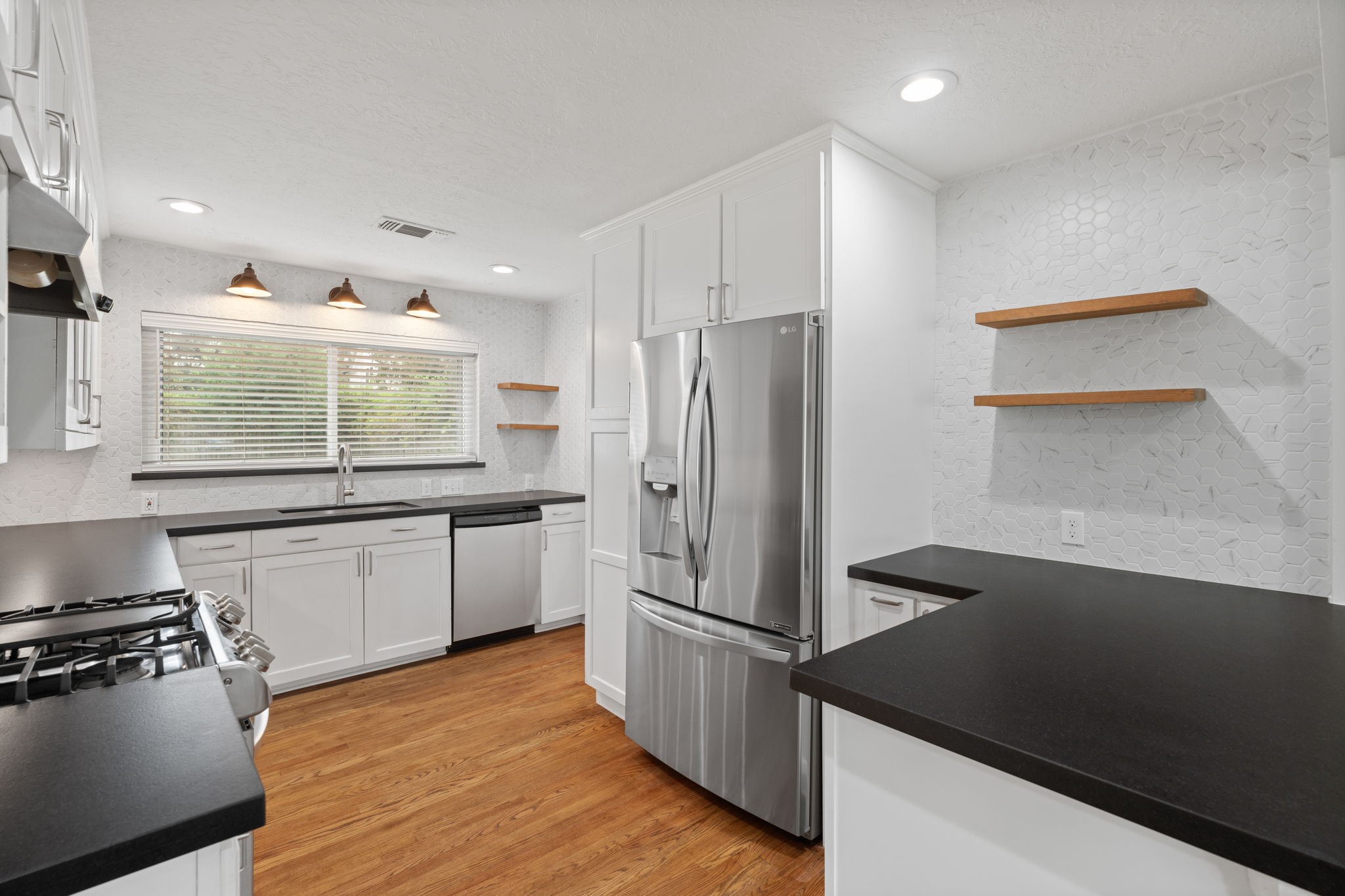 2007 Wakefield Drive Houston, TX 77018 - Photo 10 of 29 Fully updated kitchen featuring modern finishes with warm, inviting touches. Thoughtfully designed for cooking and open to the dining area, making meal prep and entertaining both easy and enjoyable.