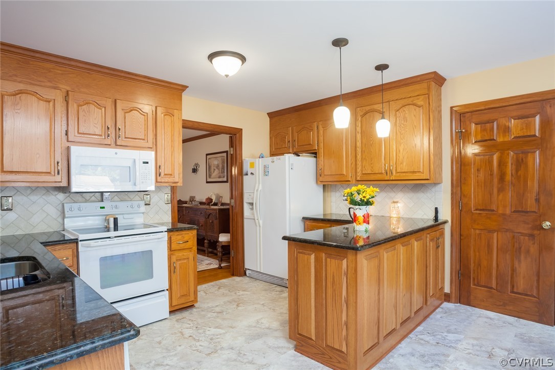 9212 Cattail Road Chesterfield, VA 23838 - Photo 16 of 47 a kitchen with stainless steel appliances granite countertop a refrigerator a sink dishwasher and wooden cabinets with wooden floor