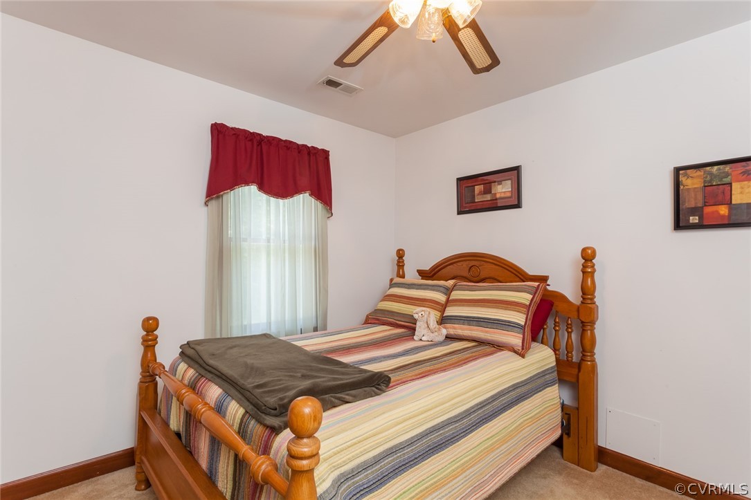 9212 Cattail Road Chesterfield, VA 23838 - Photo 27 of 47 a bedroom with a bed and a chandelier