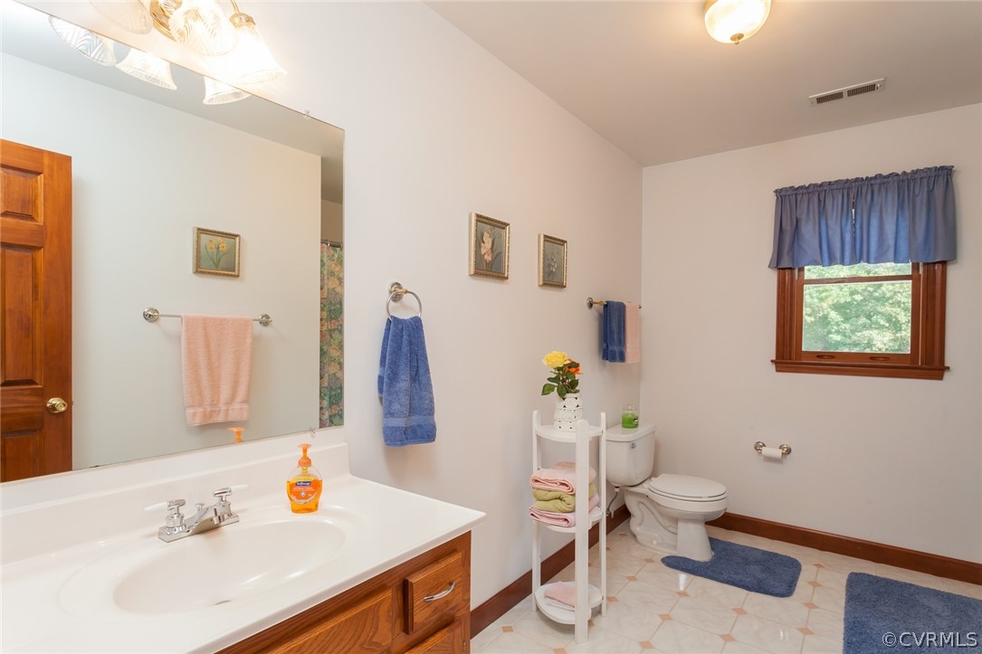 9212 Cattail Road Chesterfield, VA 23838 - Photo 31 of 47 a bathroom with a sink mirror vanity and toilet