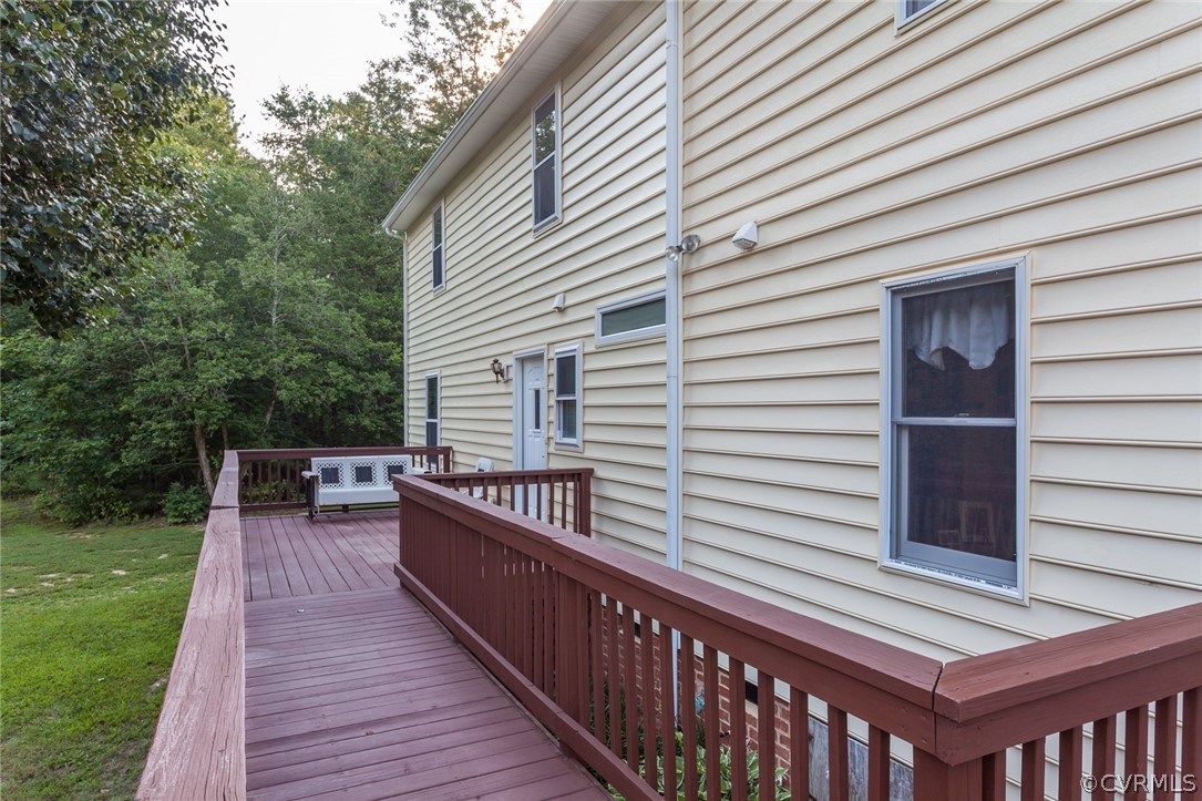 9212 Cattail Road Chesterfield, VA 23838 - Photo 43 of 47 a view of a roof deck with wooden floor and fence and a floor to ceiling window