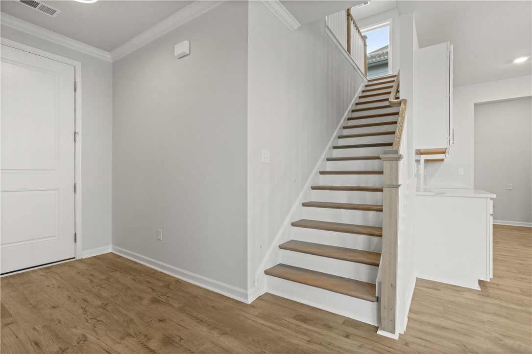 631 Sweetspire Trail, Unit 148 Seneca, SC 29678 - Photo 20 of 36 Clean lines and wood flooring create a welcoming entry, leading up a graceful staircase to upper levels.