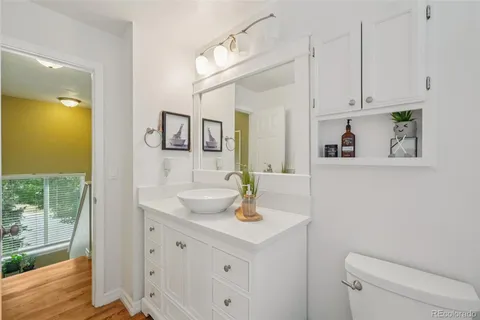 a bathroom with a sink a toilet and mirror