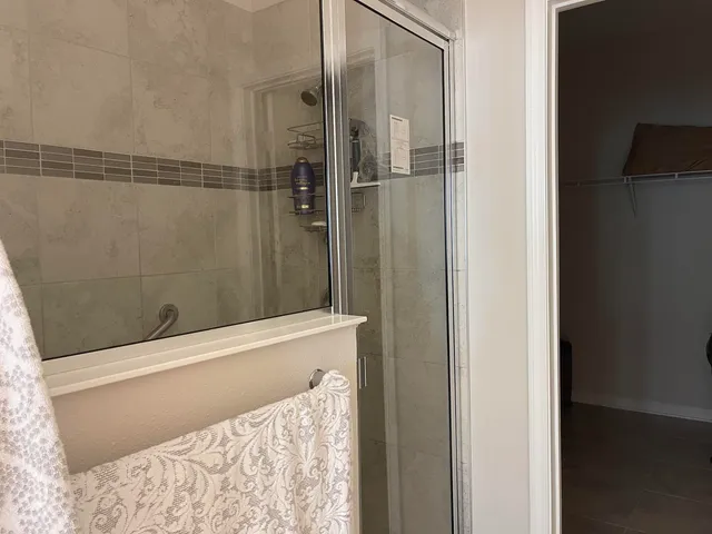 a bathroom with a bathtub and shower
