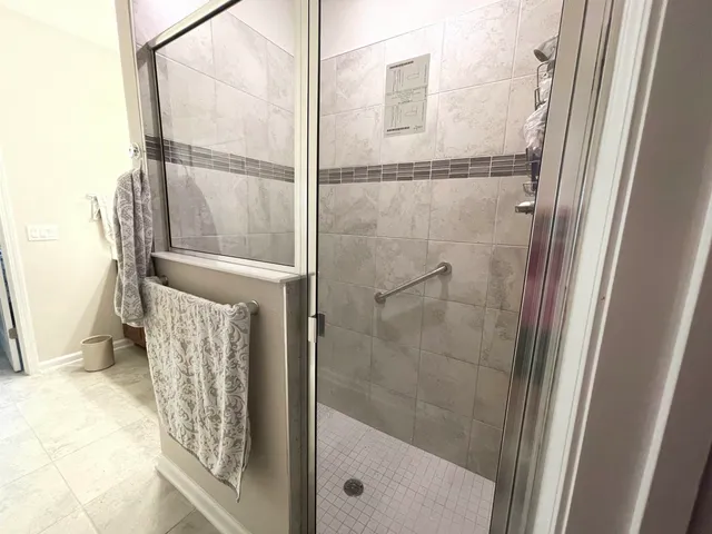 a bathroom with a glass shower door
