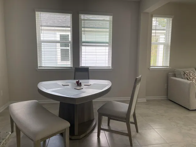 a view of a dining room with furniture and window