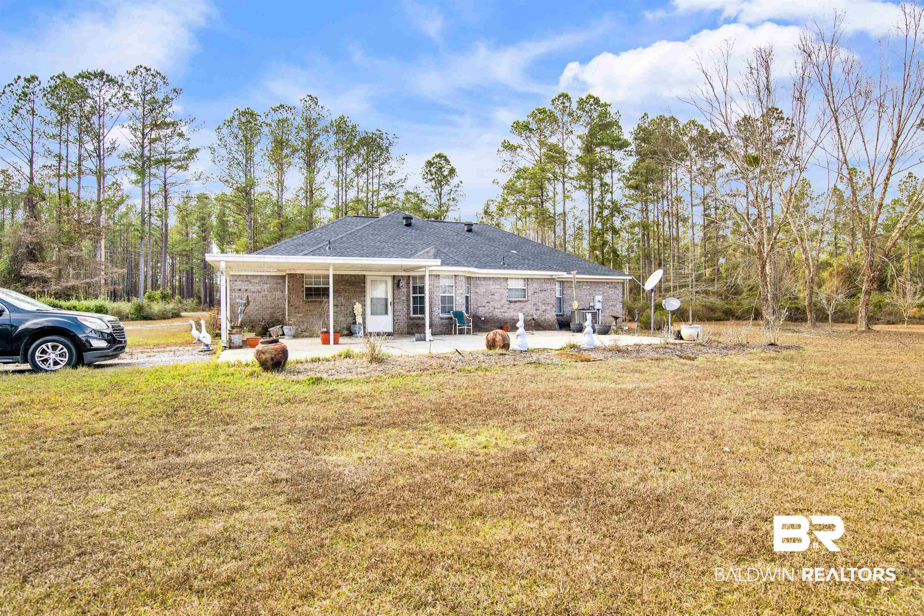 36434 Alexandria Trail Stapleton, AL 36578 - Photo 20 of 27 Back of property with a yard, brick siding, and a patio area