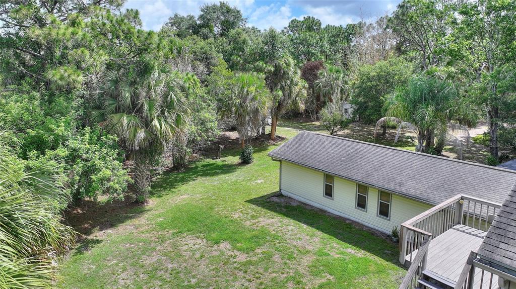 3641 Turtle Mound Road Melbourne, FL 32934 - Photo 60 of 77 a view of a house with a big yard plants and large trees