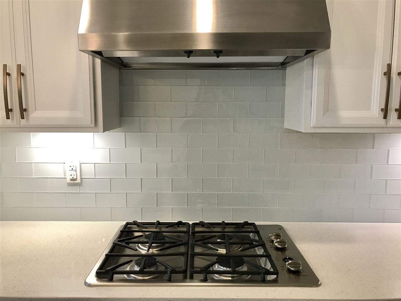 2506 Rambling Creek Road, Unit 32 Apex, NC 27523 - Photo 6 of 30 Gas cooktop, glass backsplash and range hood that vents outside Kitchen