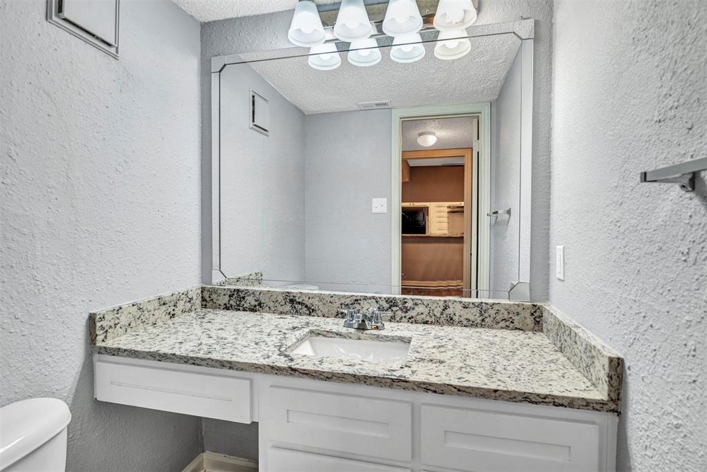 11311 Audelia Road, Unit 221 Dallas, TX 75243 - Photo 14 of 22 a bathroom with a granite countertop sink and a mirror
