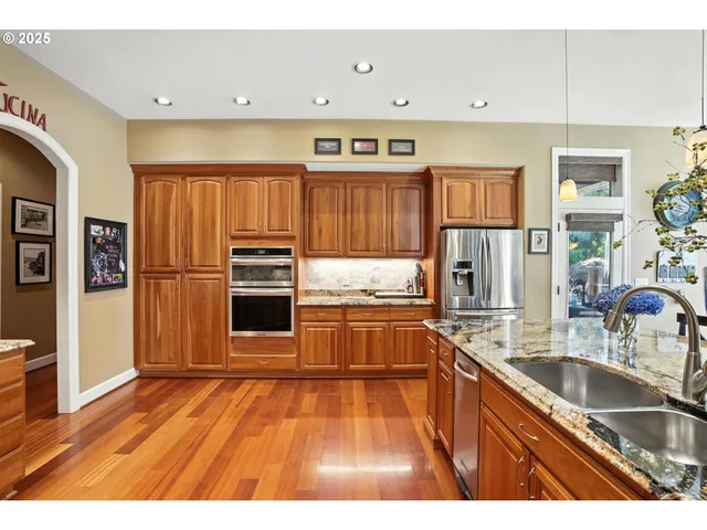 a dining room with furniture a large window and wooden floor