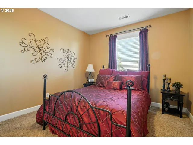 a spacious bedroom with a bed and a large window