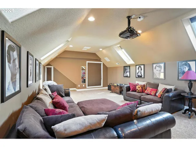 a spacious bedroom with a bed and a chandelier