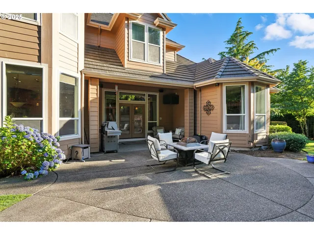 a view of backyard with outdoor seating and green space