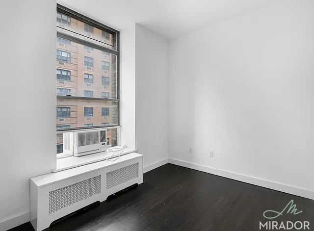 a view of wooden floor and windows in a room