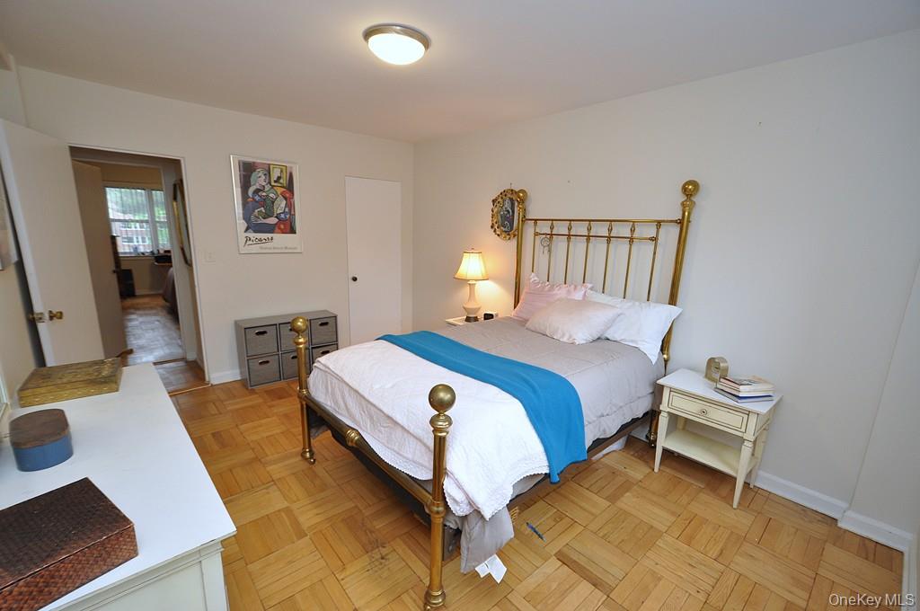 235 Garth Road, Unit A5B Scarsdale, NY 10583 - Photo 23 of 47 a bedroom with a bed and wooden floor