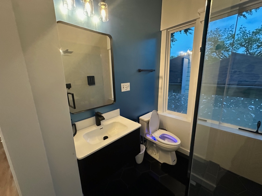 3210 Hampton Road, Unit A B C Austin, TX 78705 - Photo 12 of 39 a bathroom with a sink mirror and toilet