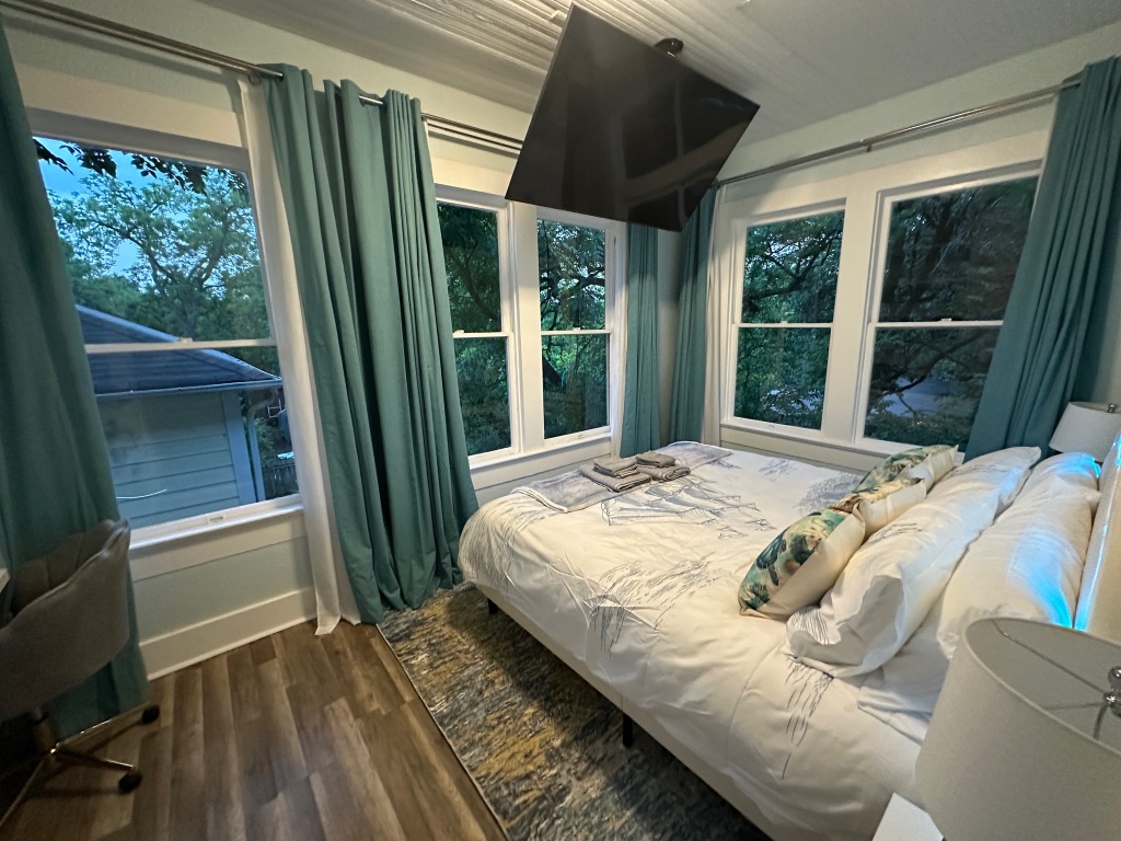 3210 Hampton Road, Unit A B C Austin, TX 78705 - Photo 13 of 39 a bed sitting in a bedroom next to a window