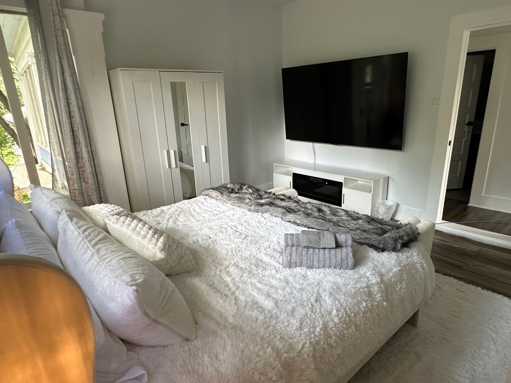 3210 Hampton Road, Unit A B C Austin, TX 78705 - Photo 20 of 39 a bedroom with a bed and a flat tv screen on the dresser