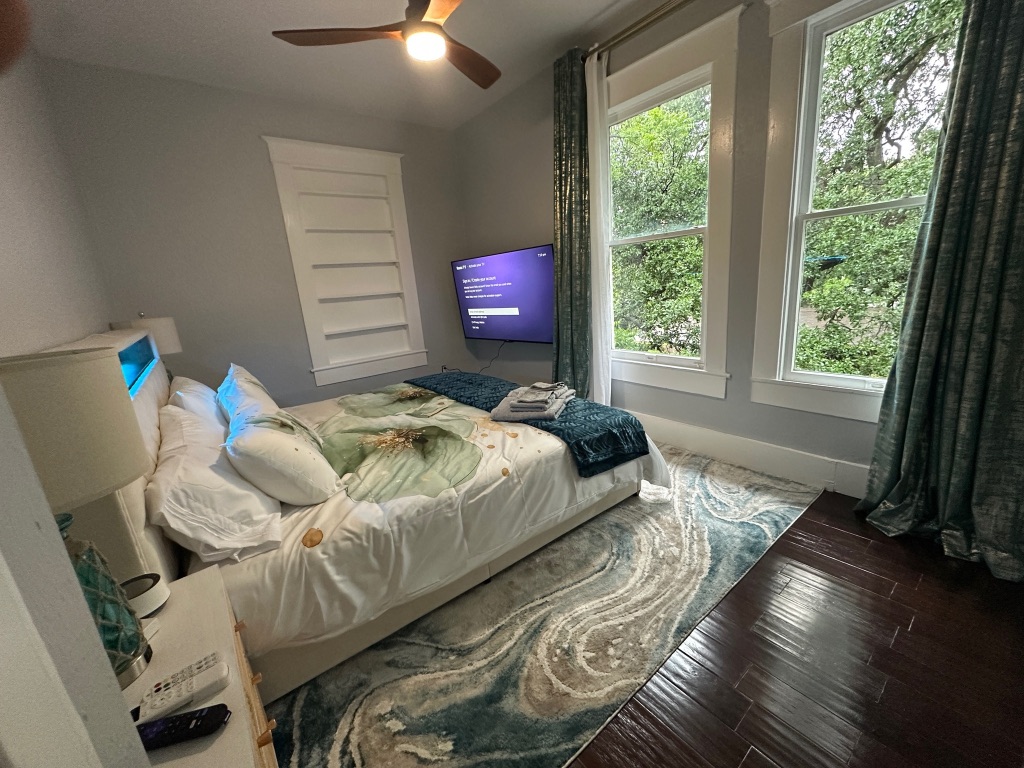3210 Hampton Road, Unit A B C Austin, TX 78705 - Photo 2 of 39 a bedroom with a bed and a window