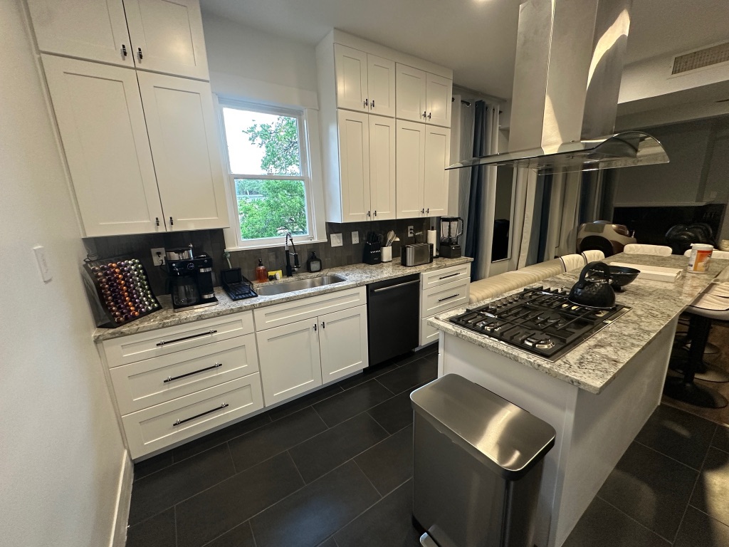 3210 Hampton Road, Unit A B C Austin, TX 78705 - Photo 3 of 39 a kitchen with a stove a sink and a refrigerator