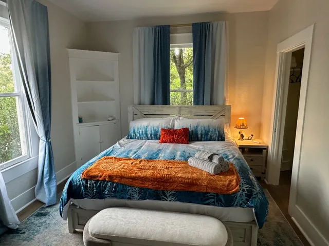 a bedroom with a bed and a window