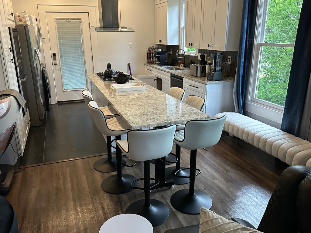 3210 Hampton Road, Unit A B C Austin, TX 78705 - Photo 4 of 39 a kitchen with stainless steel appliances granite countertop a table chairs stove and a refrigerator