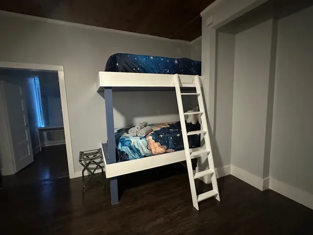 a room with wooden floor and white walls