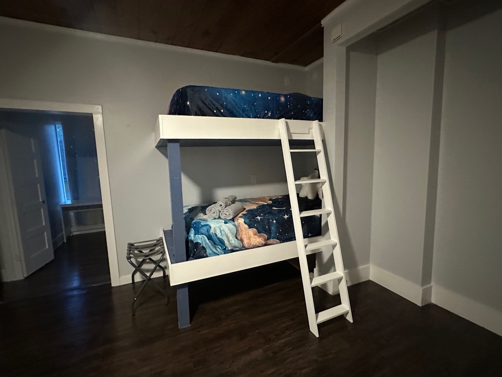 3210 Hampton Road, Unit A B C Austin, TX 78705 - Photo 10 of 39 a room with wooden floor and white walls