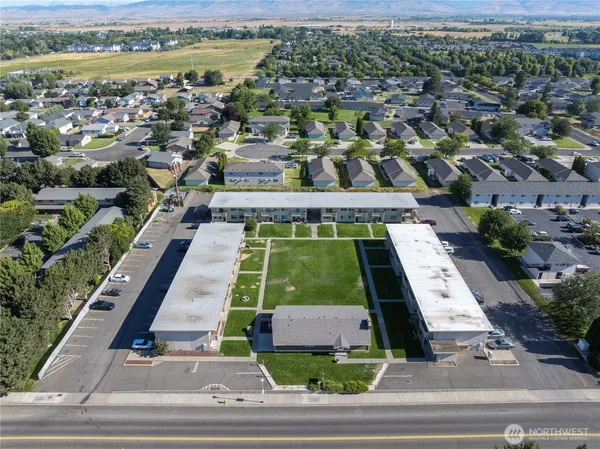 an aerial view of residential houses with outdoor space