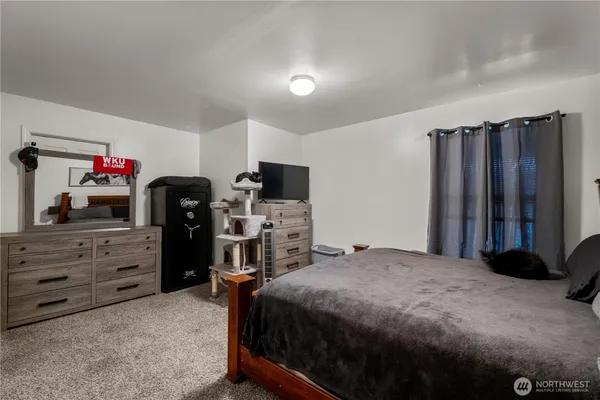a bedroom with a bed and a mirror