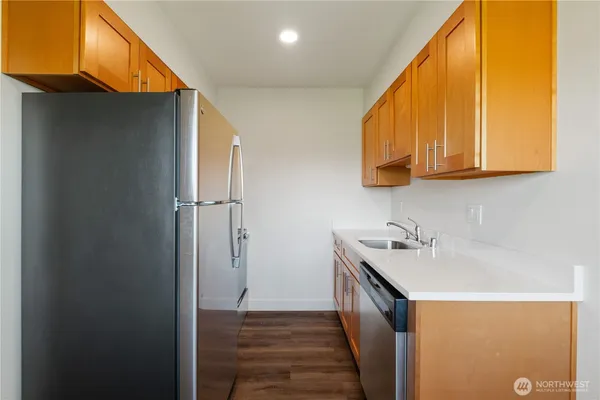 a kitchen with stainless steel appliances granite countertop a sink a stove and a microwave