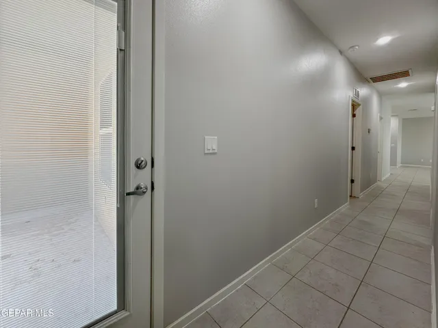 an empty room with a ceiling fan and a window
