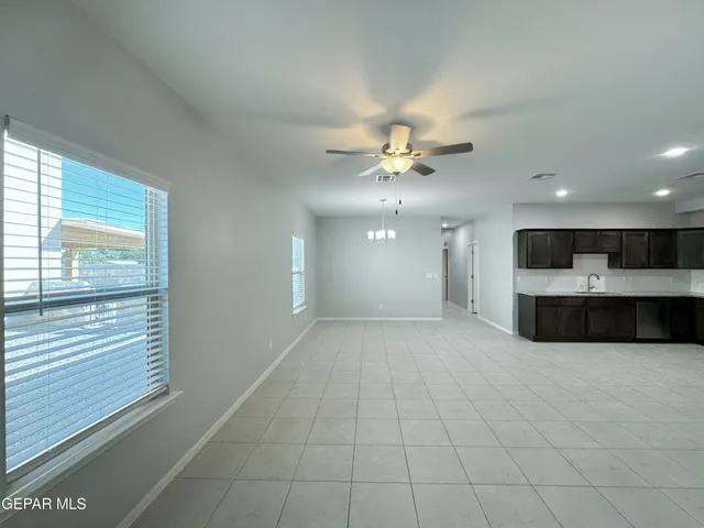 a view of an empty room with a kitchen