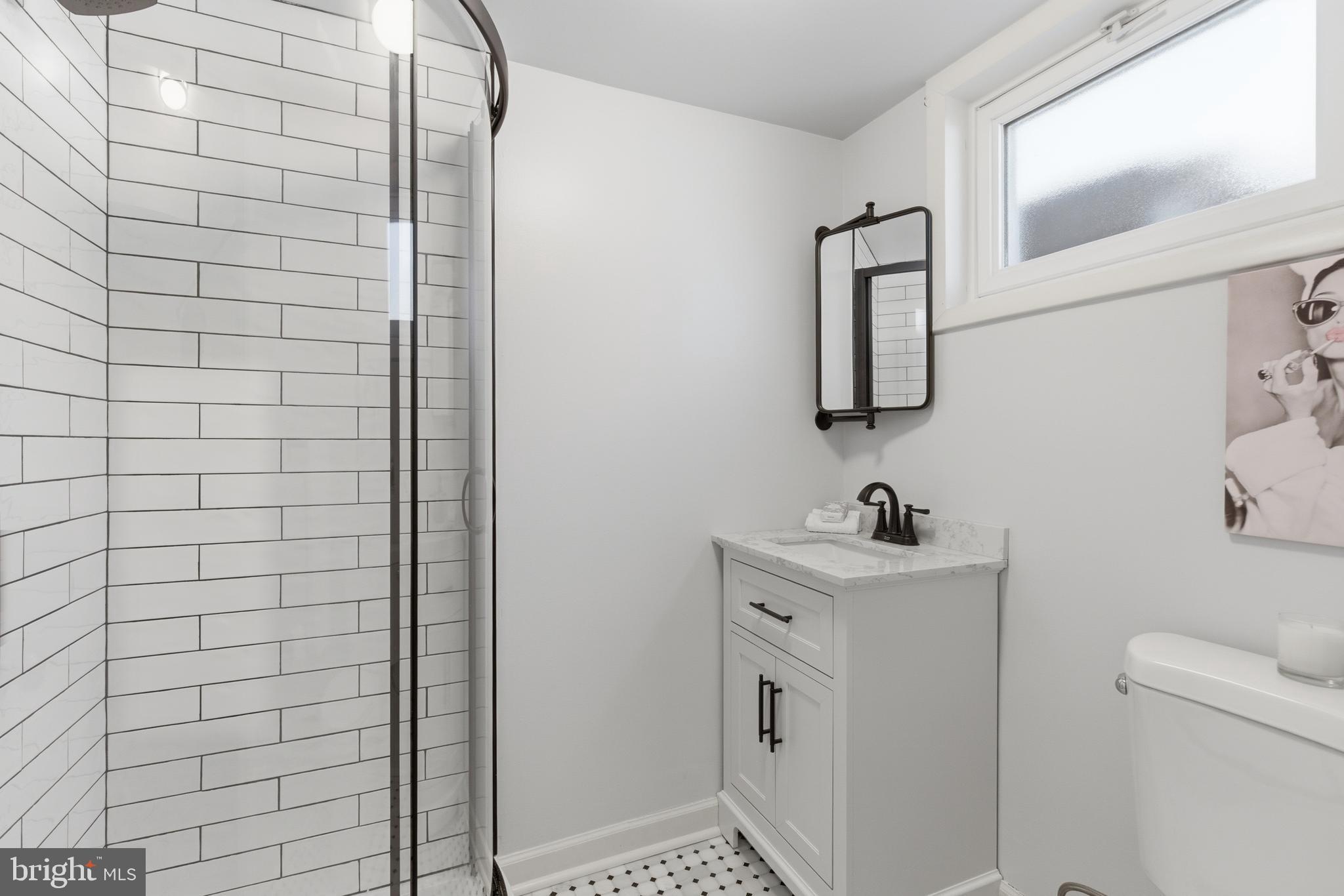 5020 Alta Vista Road Bethesda, MD 20814 - Photo 30 of 41 a bathroom with a sink toilet and mirror