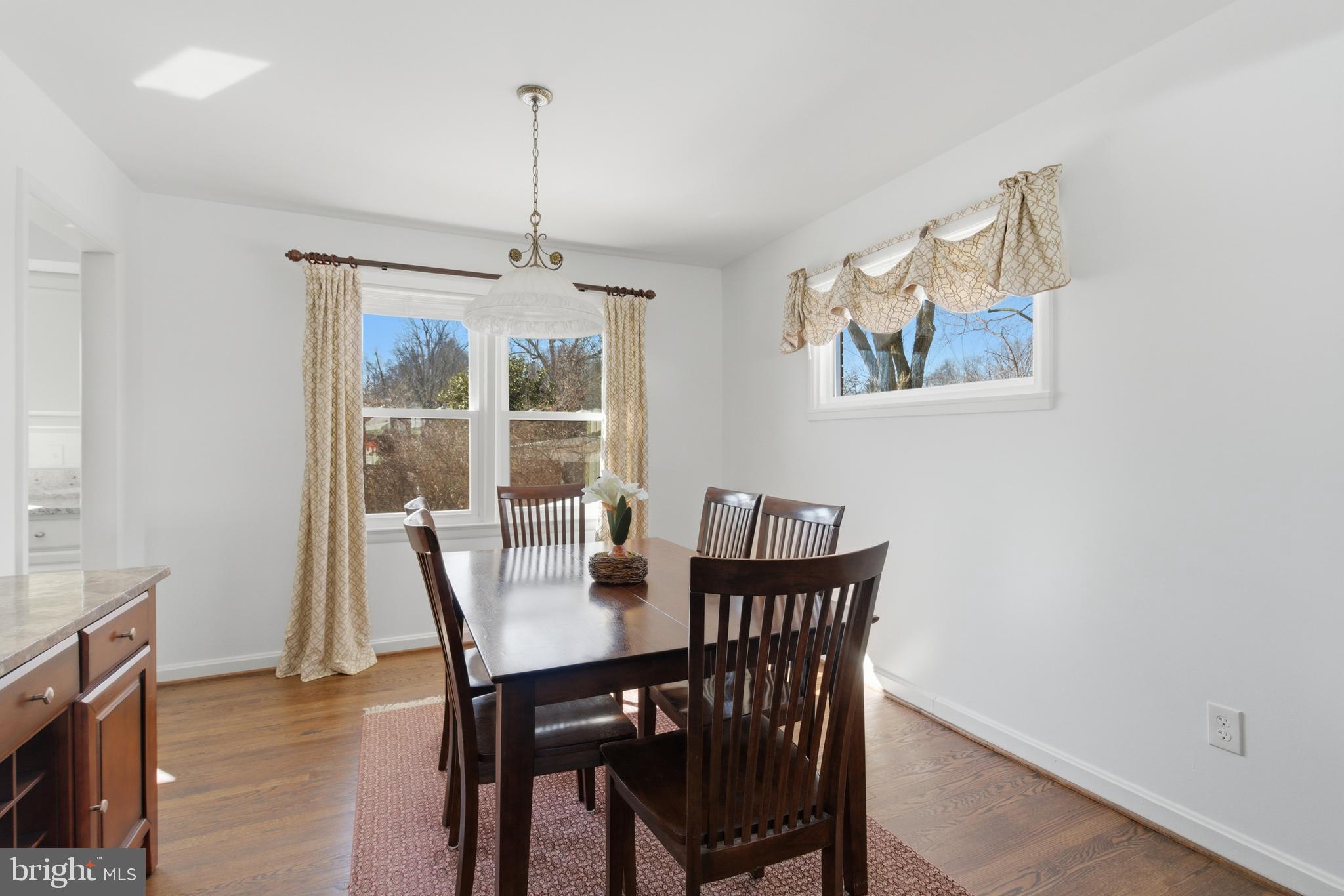 5020 Alta Vista Road Bethesda, MD 20814 - Photo 7 of 41 a view of a dining room with furniture window and wooden floor