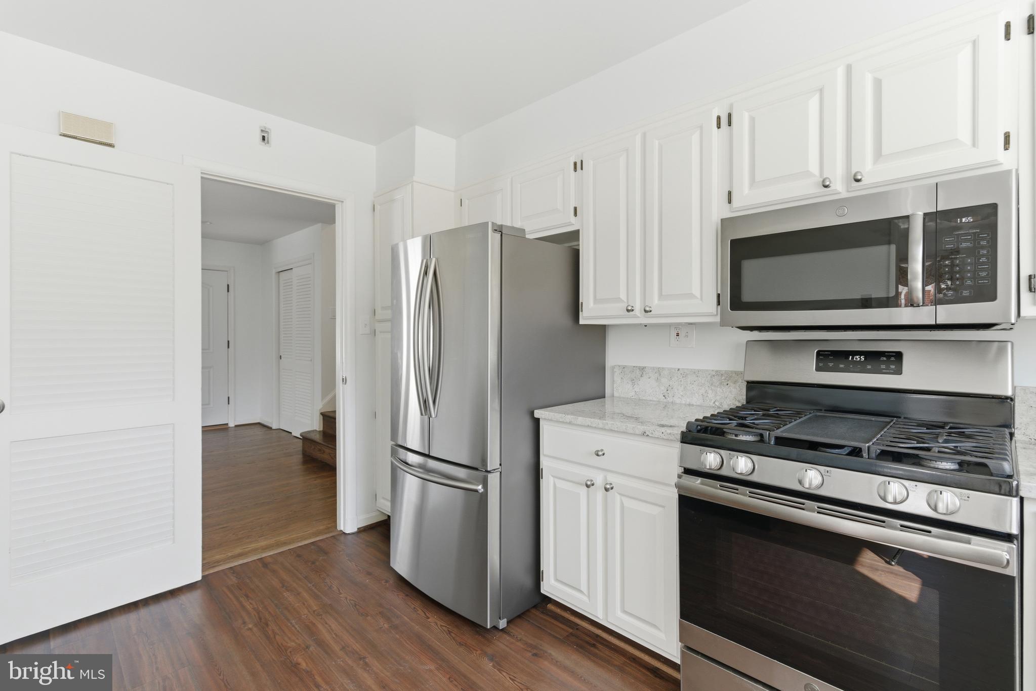 5020 Alta Vista Road Bethesda, MD 20814 - Photo 8 of 41 a kitchen with stainless steel appliances a refrigerator stove and microwave