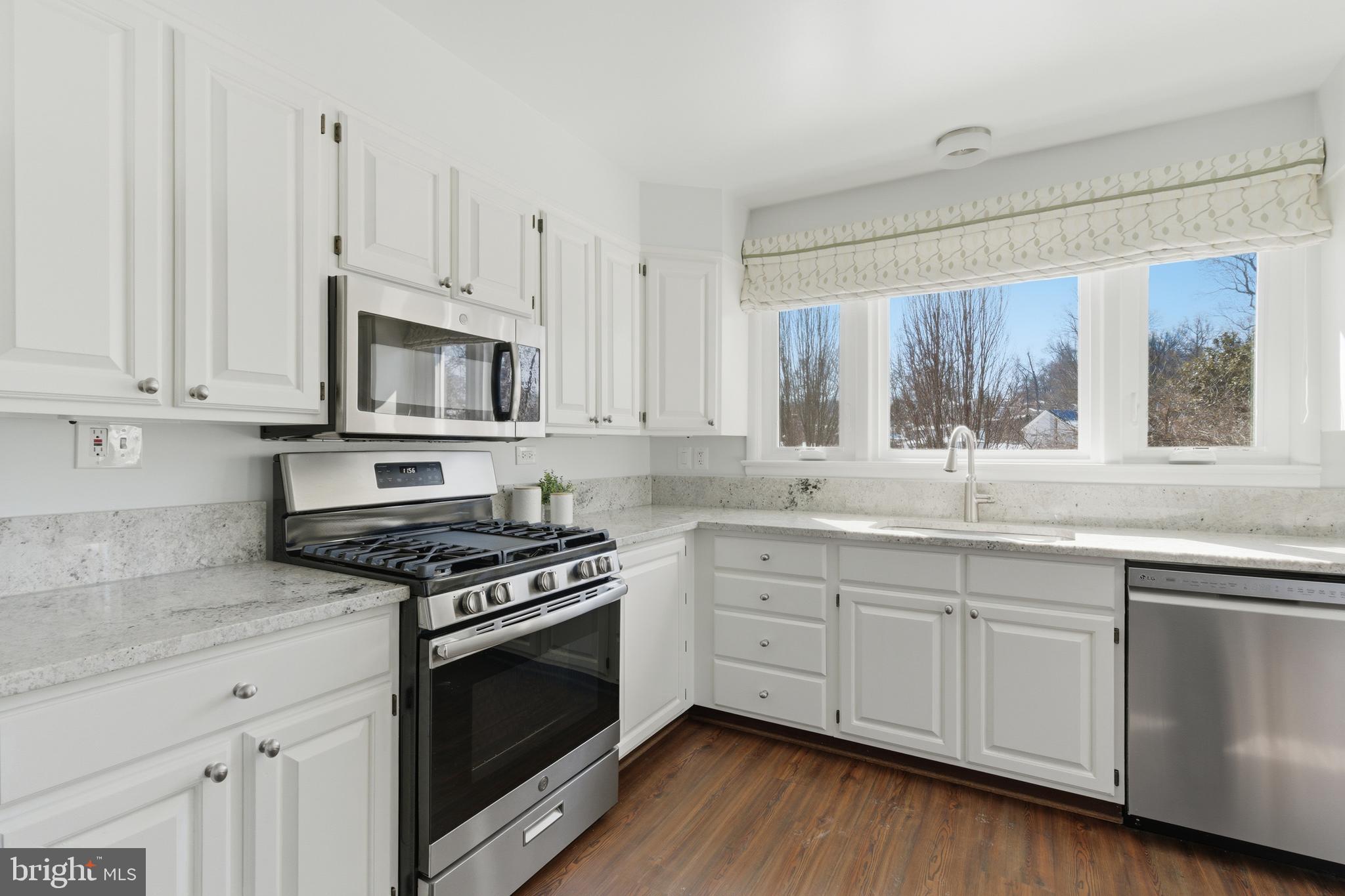 5020 Alta Vista Road Bethesda, MD 20814 - Photo 10 of 41 a kitchen with granite countertop white cabinets and appliances