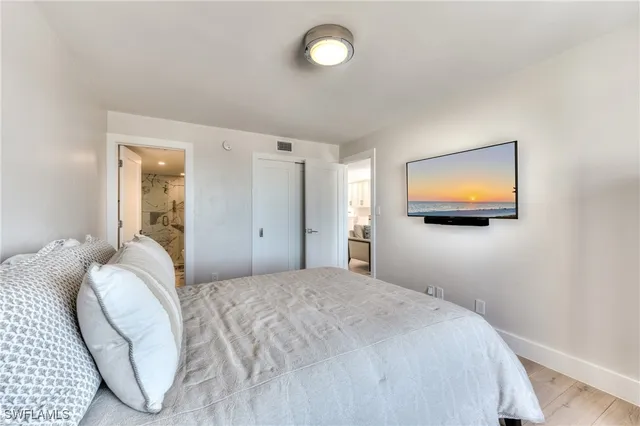 a bedroom with a bed and a flat screen tv