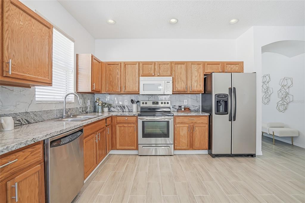 12351 Ridgedale Drive Hudson, FL 34669 - Photo 12 of 48 a kitchen with a refrigerator sink and cabinets